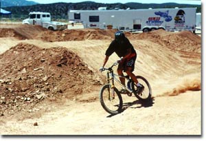 Troy powersliding into right turn off double jump at Cedar raceway